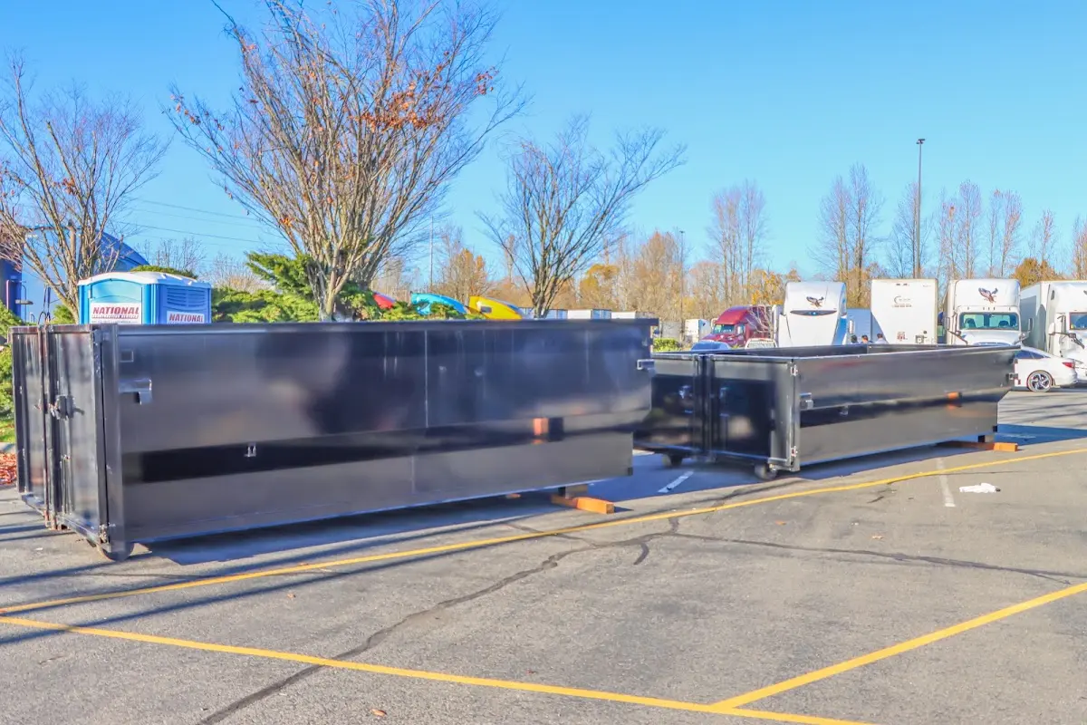 Professional dumpster rental service with roll-off container on residential driveway in Benton Harbor